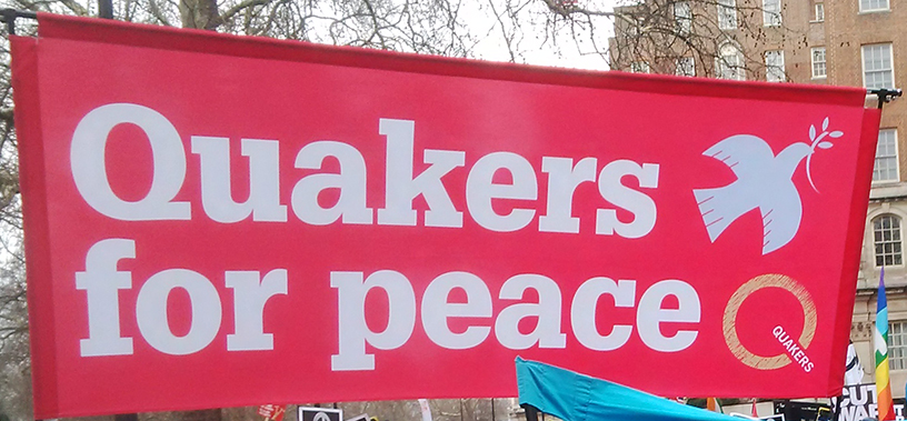 Brilliant pink banner says Quakers for peace