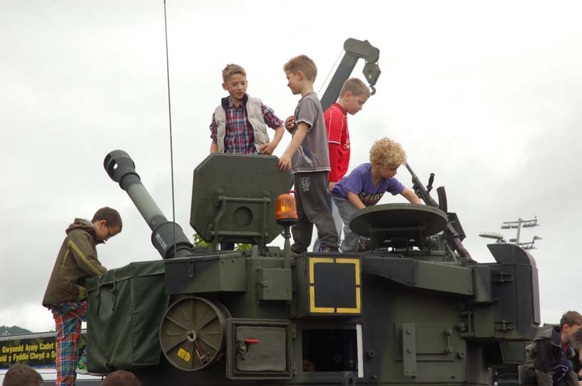 children clambering over tank