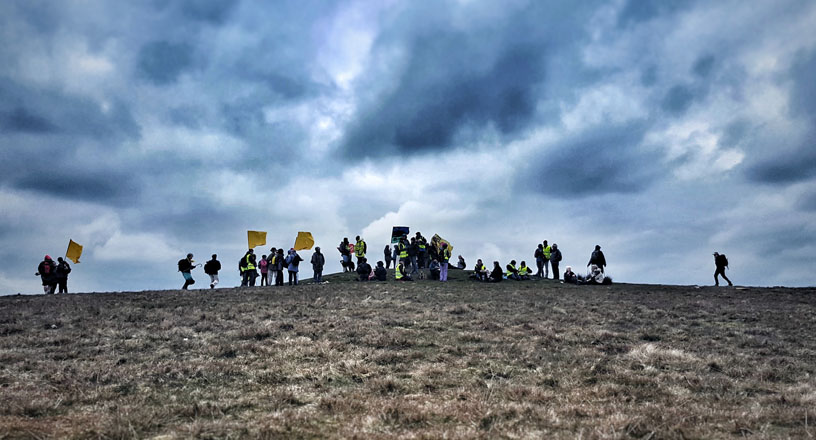 Quakers at the top of Pendle Hill, holding banners against fracking
