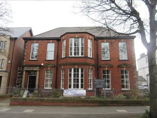 Red brick and ashlar design building with many windows.