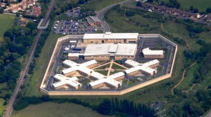 Aerial photo of a prison surrounded by green fields
