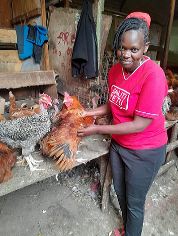 One of the group members taking care of the groups chicken rearing project. The group underwent the one-day finance literacy training.