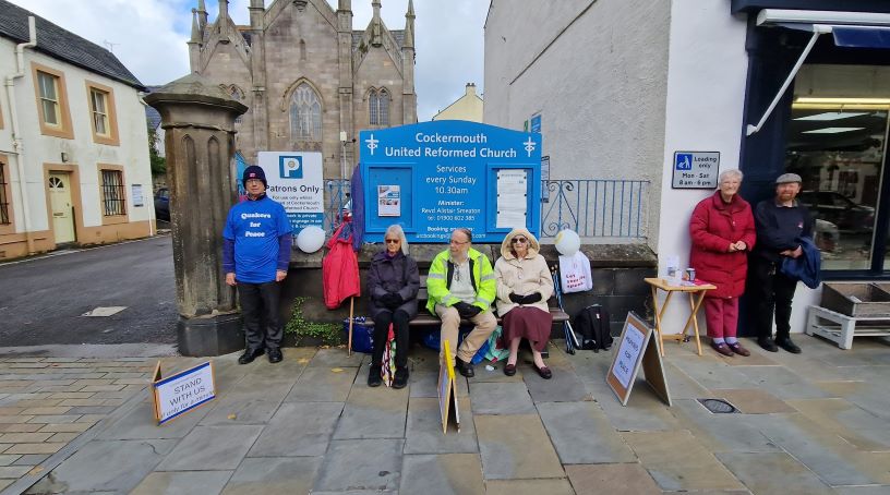 Quakers sit and stand together for peace vigil on high street