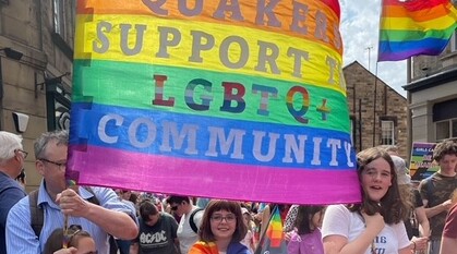 A Quaker banner at Lancaster Pride on a rainbow flag reads 'Quakers support the LGBTQ+ community'