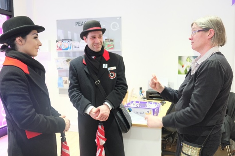 Two tour guides talking to a woman