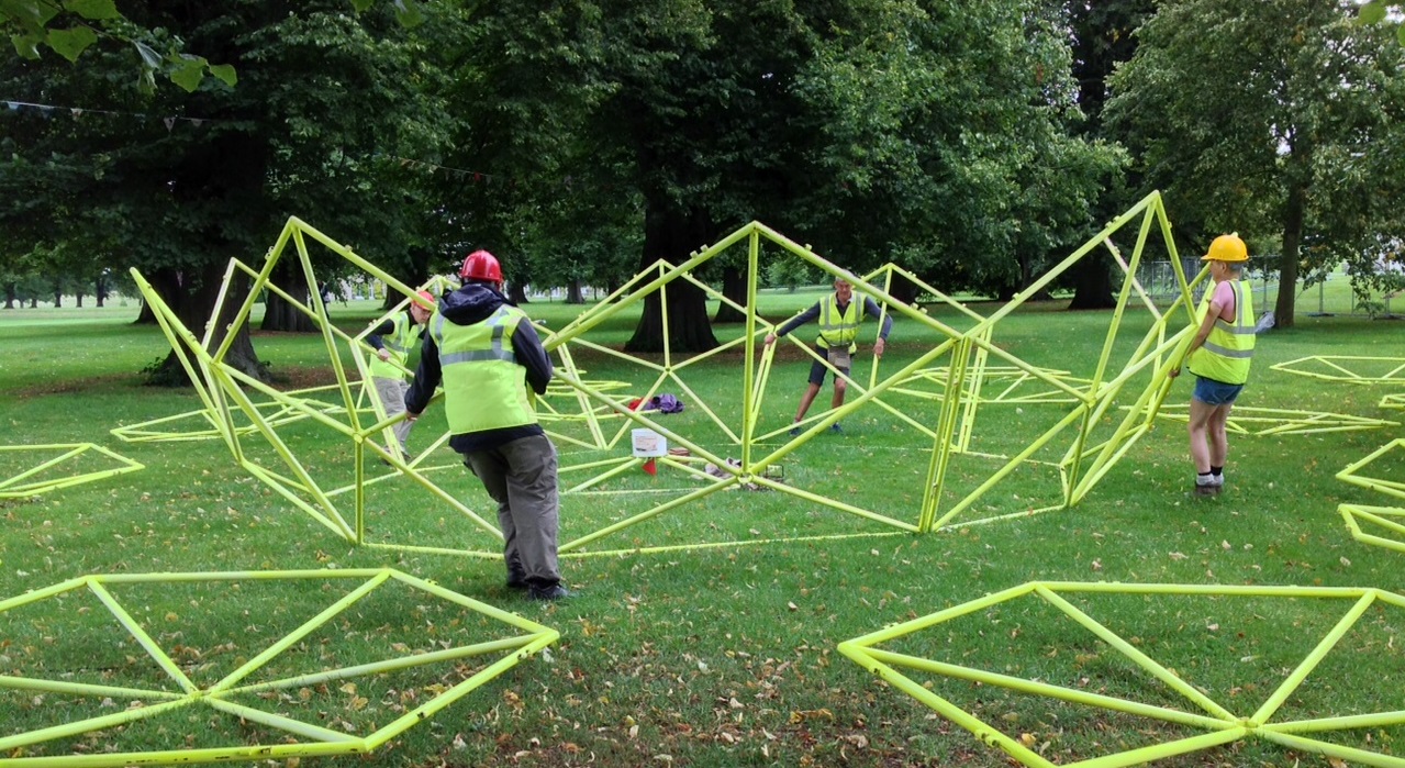 Four people moving dome structure