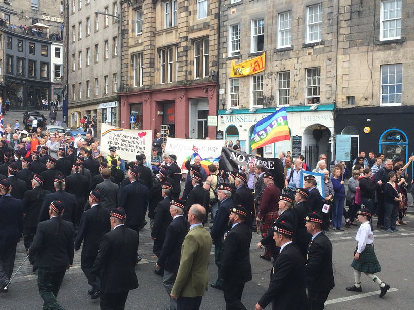 Quaker peace banners behind veterans' parade