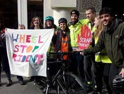 Young Quakers in front of banner reading Wheel Stop Trident