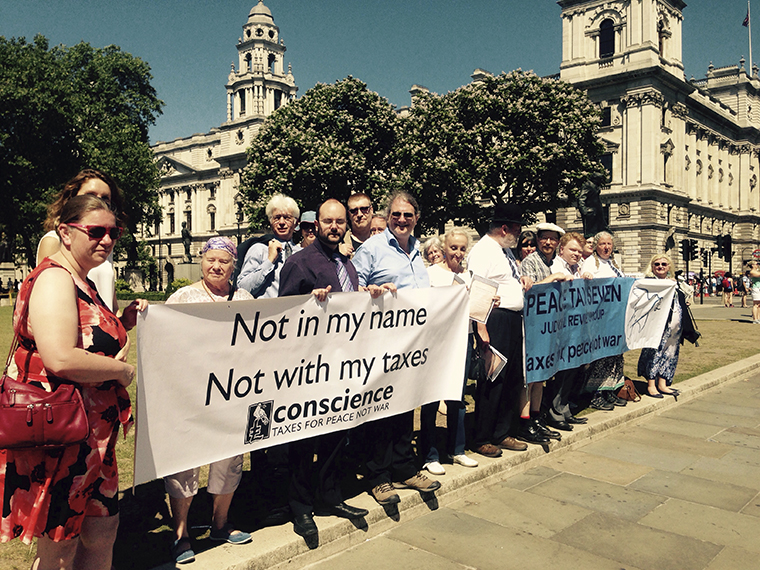 A dozen supporters of the Taxes for Peace Bill outside parliament 