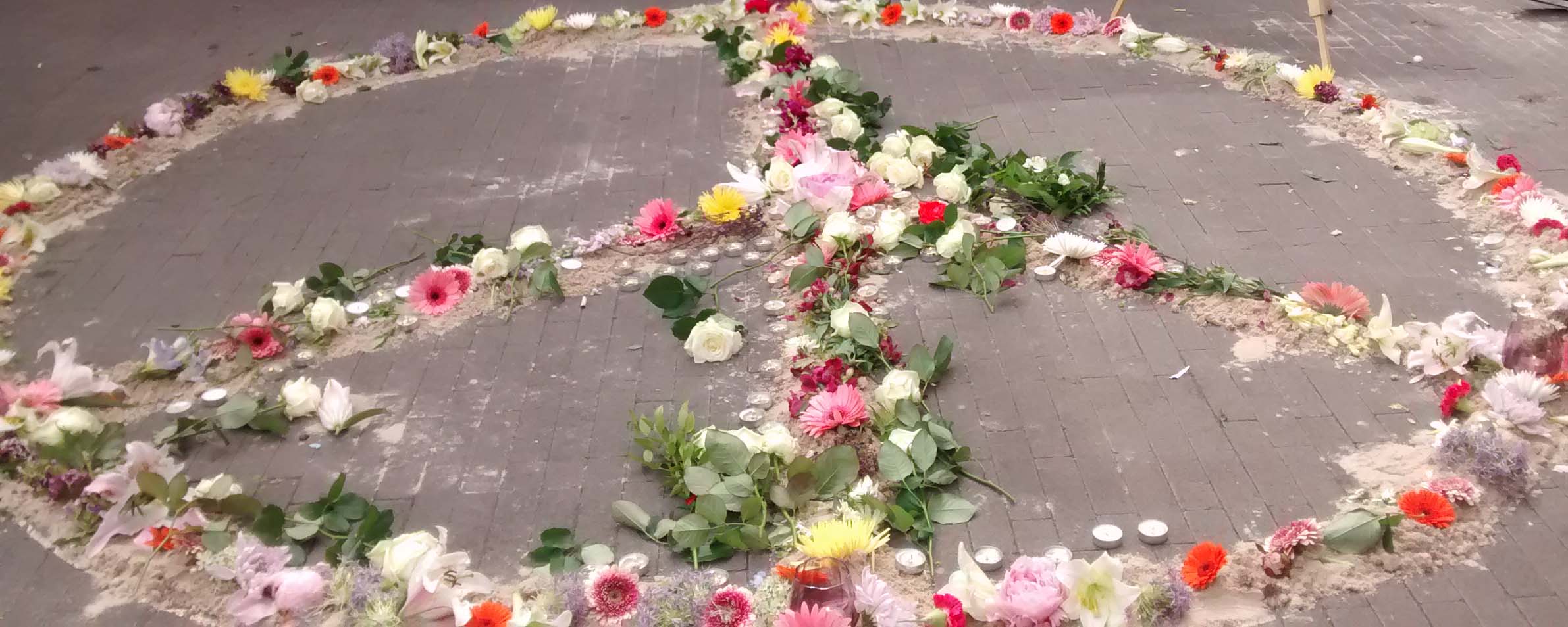 flowers and candles maring a peace sign