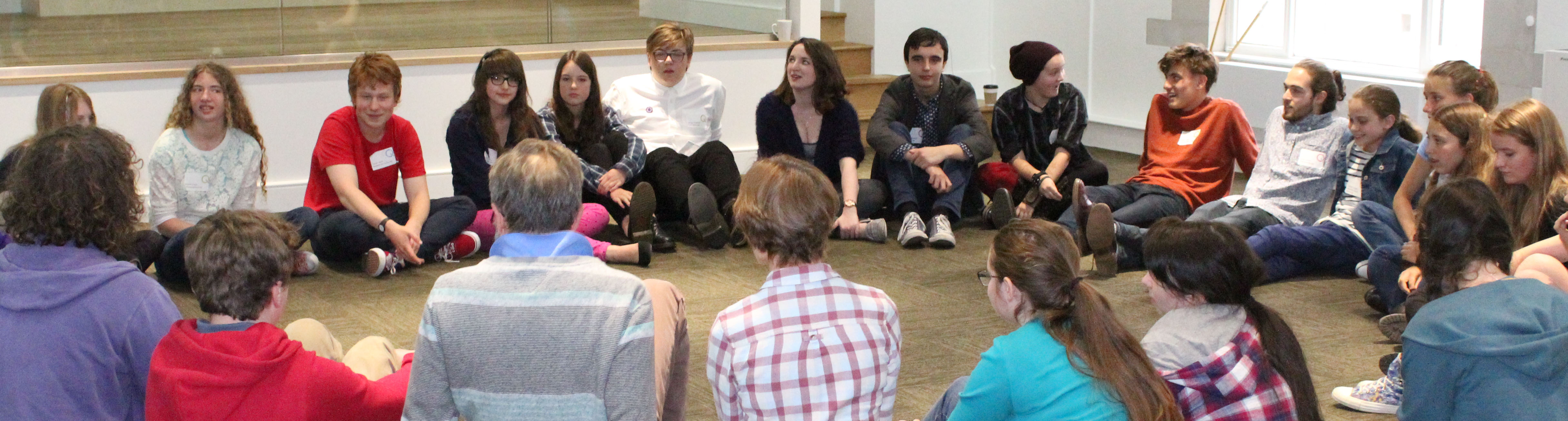 Group of young people sat in a circle