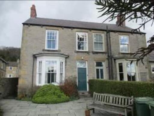 Originally two-storey semi-detached house with a bench in the front.