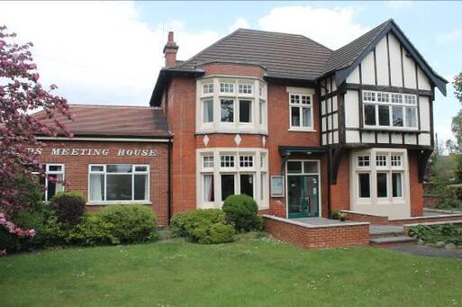 Substantial Edwardian detached house separated by hedge.