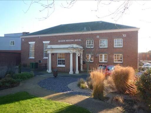 Substantial early nineteenth century meeting house with impressive entrance raised up on columns.