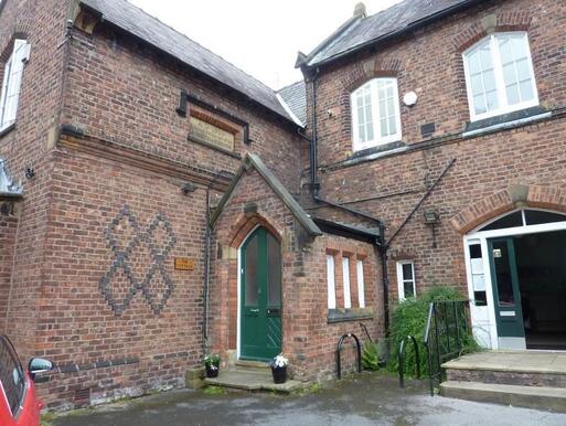 Suburban mid-nineteenth century house with large burial grounds and spacious car park.