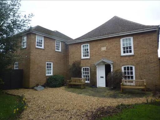 Huge one-storey house with original datestones above the door. 