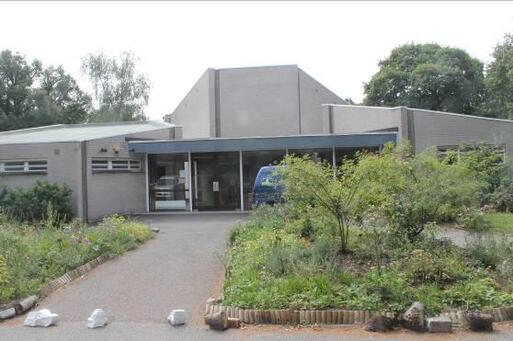 Simple modern style grey building contains the re-set headstone of Elizabeth Fry.