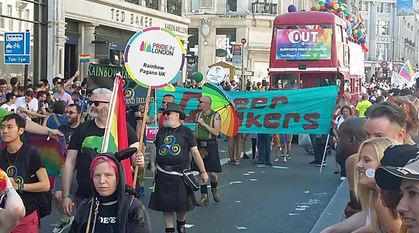 a group of Quakers at Pride in London standing in front of a banner saying Queer Quakers