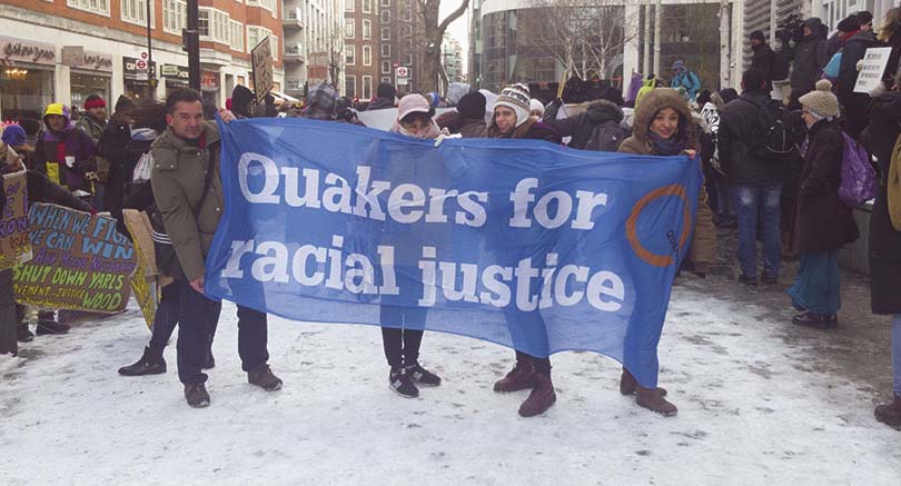 snowy demo,blue banner says Quakers for racial justice