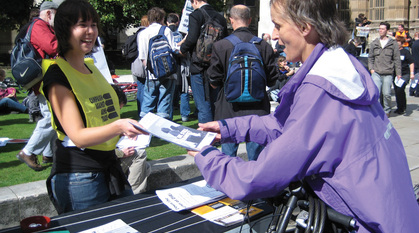 A woman handing out flyers