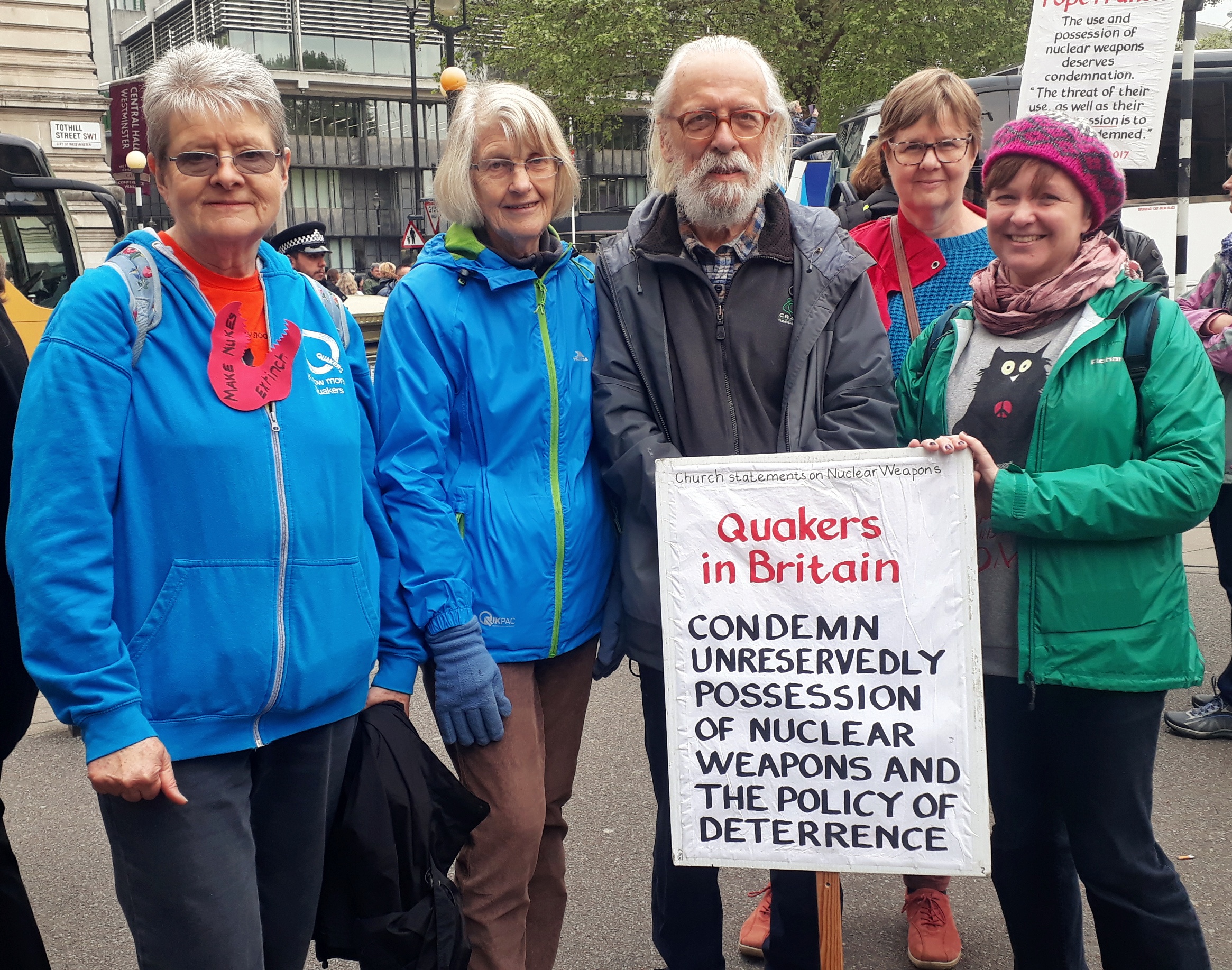 Quakers standing outside Westminster Abbey holding banners saying peace or Quakers for peace 
