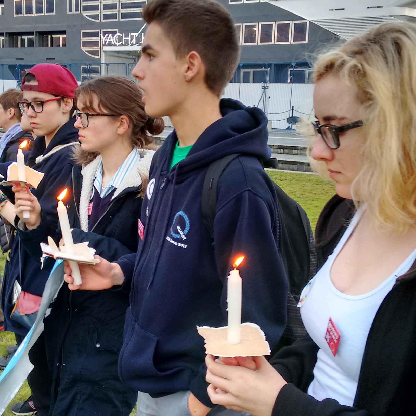 Young people with candles at peace vigil