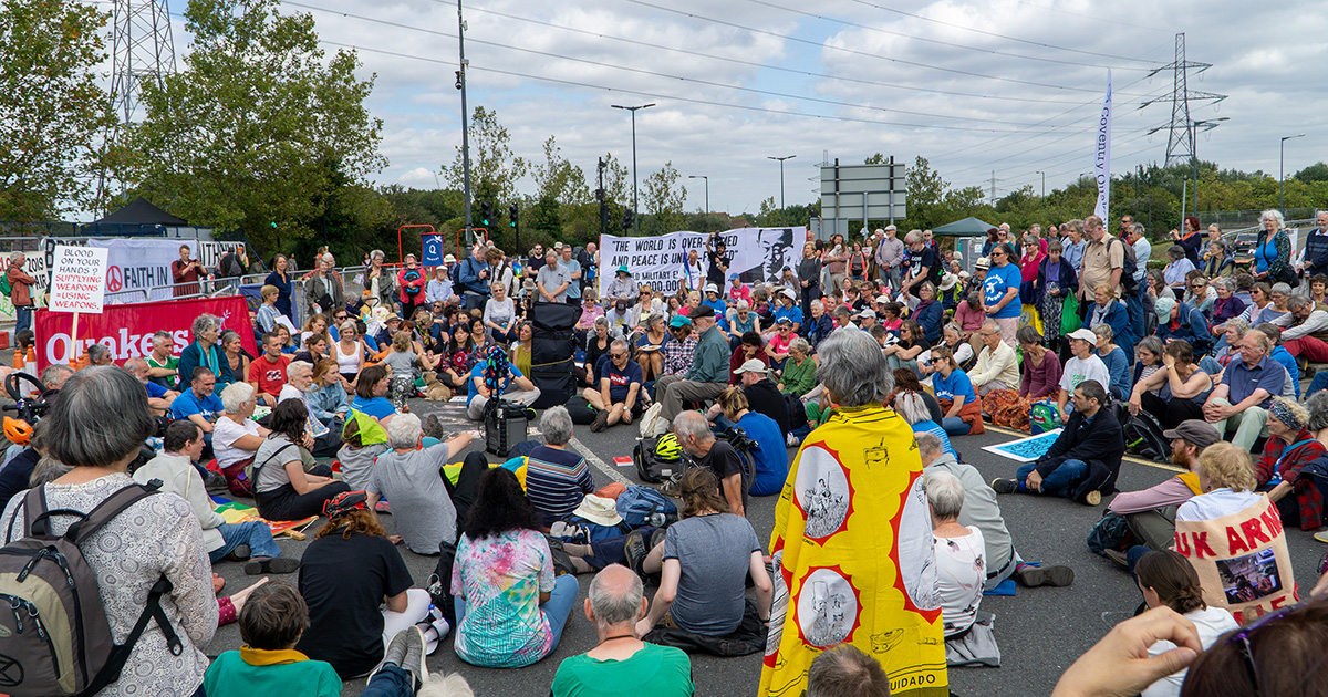 hundreds sitting standing mfw outside DSEI