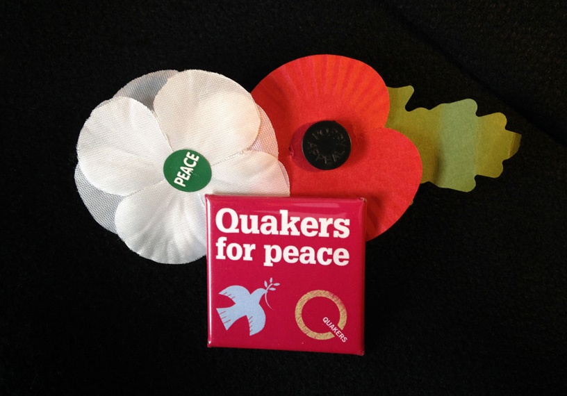 red,white poppies and peace badge