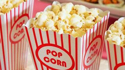 popcorn in bright red and white cinema boxes