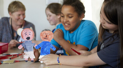 Children playing with puppets