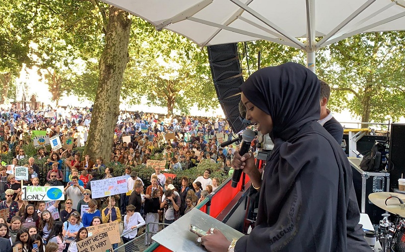 young woman addresses many climate strikers