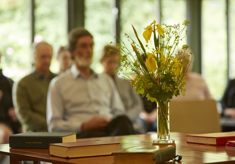 adults seated for indoor worship