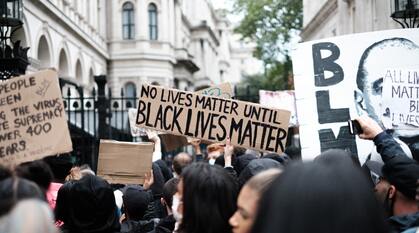 Black Lives Matter protest outside Downing Street. the main sign in shot says 'no lives matter until black lives matter'