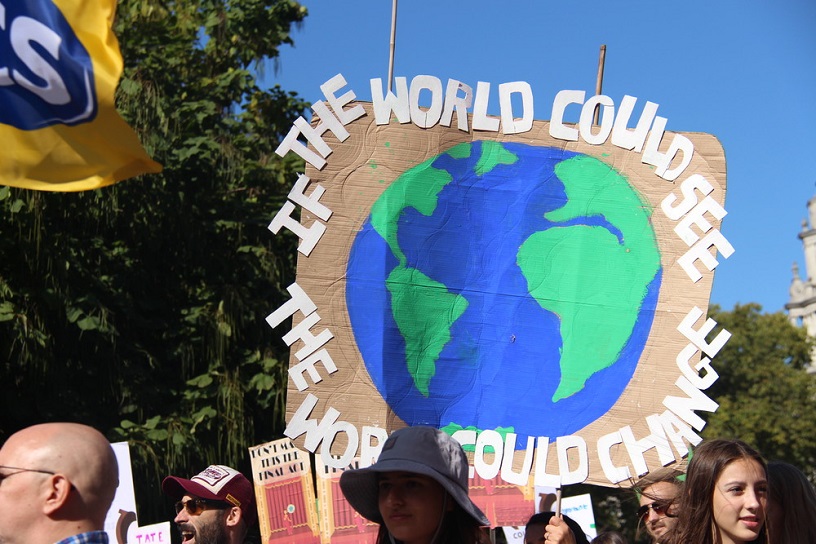 placard says if the world could see the world would change + globe