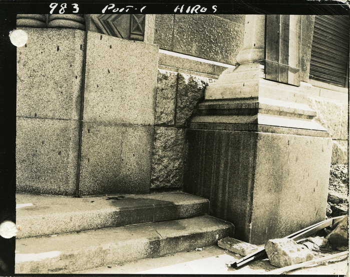 Stone steps with shadows on them and debris around