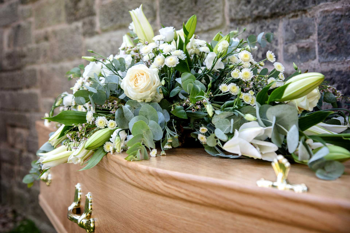coffin with flowers on top