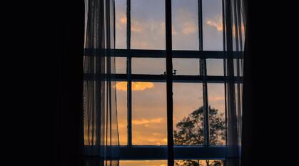 Sunset through an open sash window