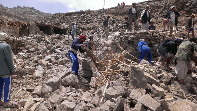 Villagers scour rubble for belongings scattered during the bombing of Hajar Aukaish, Yemen. Photo: Almigdad Mojalli/VOA