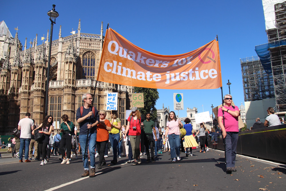 People carry a 'Quakers for climate justice' banner at a march in Westminster