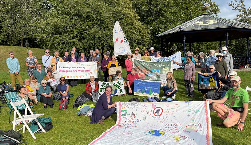 20 Qs seated on grass and banner they painted