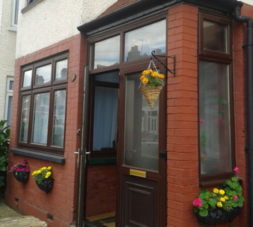 Martha House with flowering hanging baskets outside