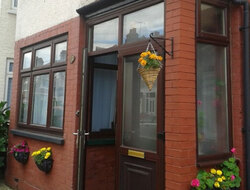 Martha House with flowering hanging baskets outside