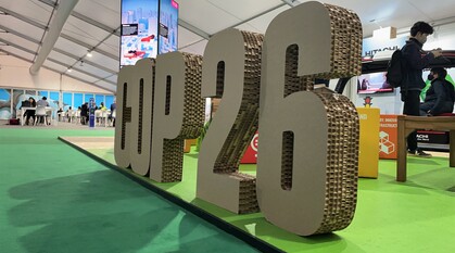 The words COP26 in giant corrugated cardboard by a stall about the sustainable development goals
