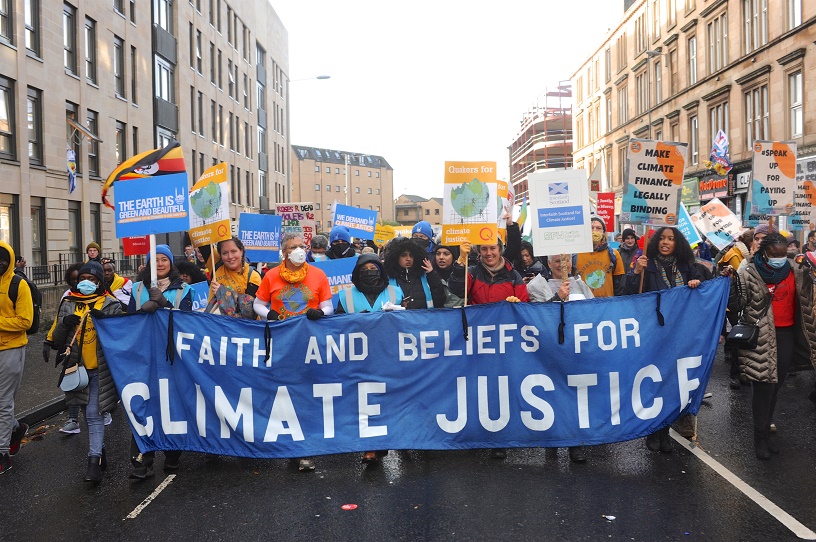 blue banner faiths bloc alongside yellow Q placards