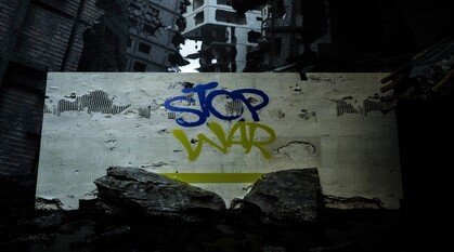 a sign saying 'stop war' in the blue and yellow of the Ukraine flag underneath bombed out buildings