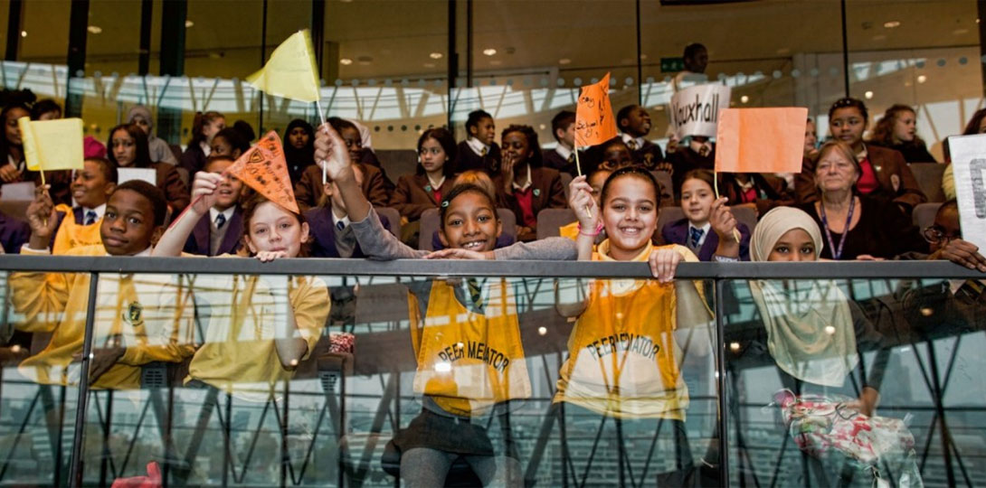 Group of children waving home-made flags