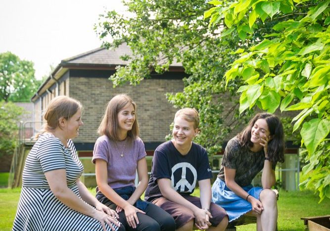 four young Quakers laughing together at Woodbrooke Quaker Centre
