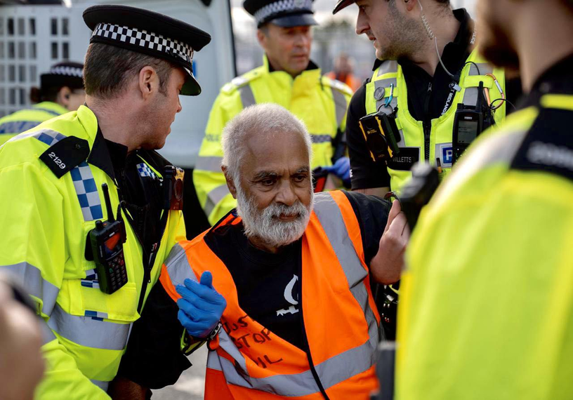 White-bearded man being arrested