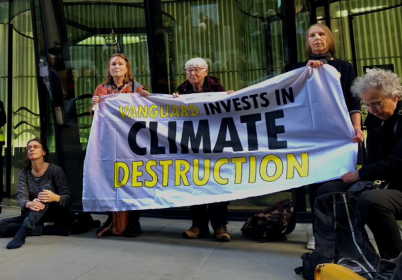 three protestors holding banner