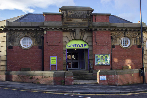 old red brick building with blue and yellow signage